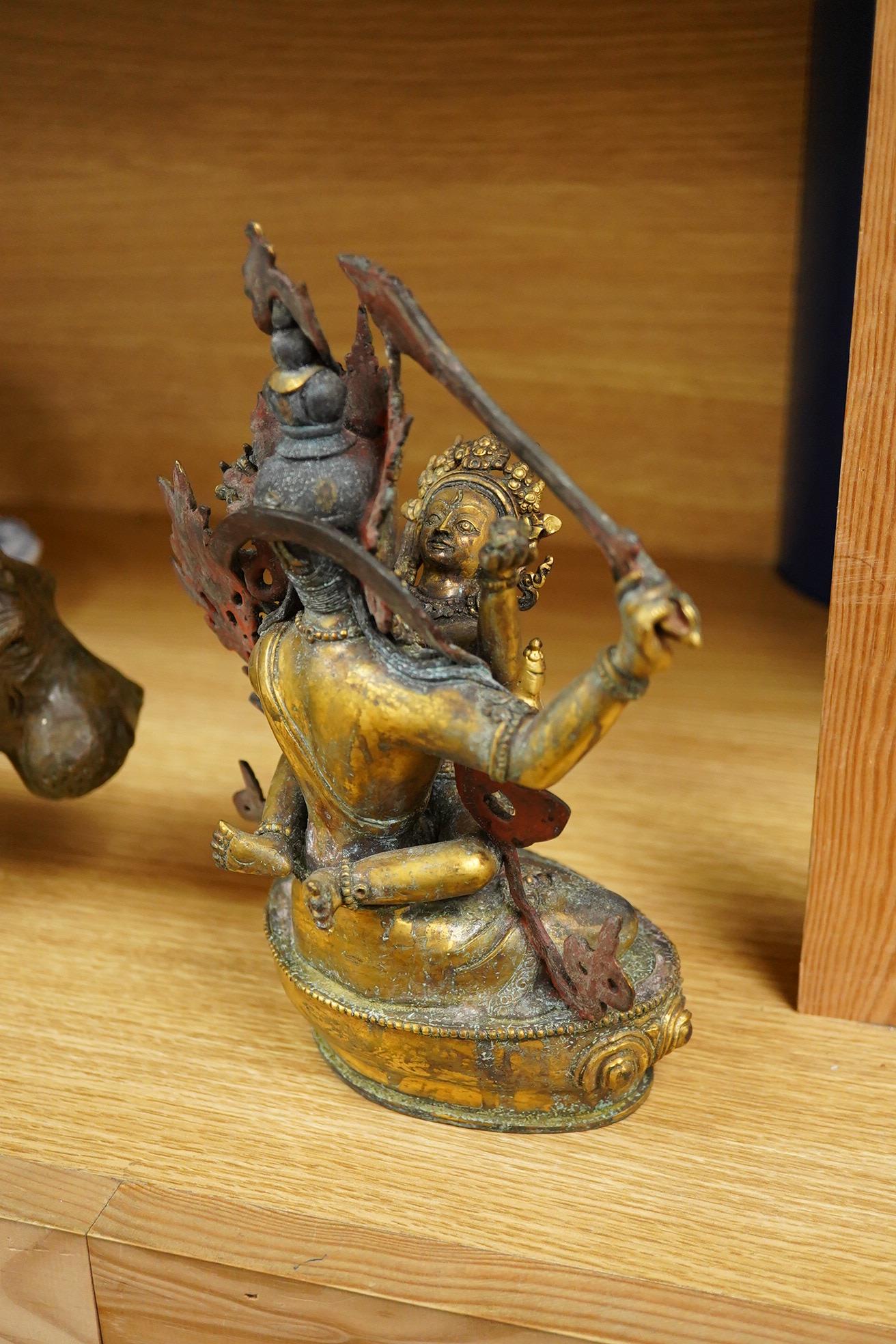 A Sino Tibetan gilt bronze group of Mahakala and consort, 22cm high